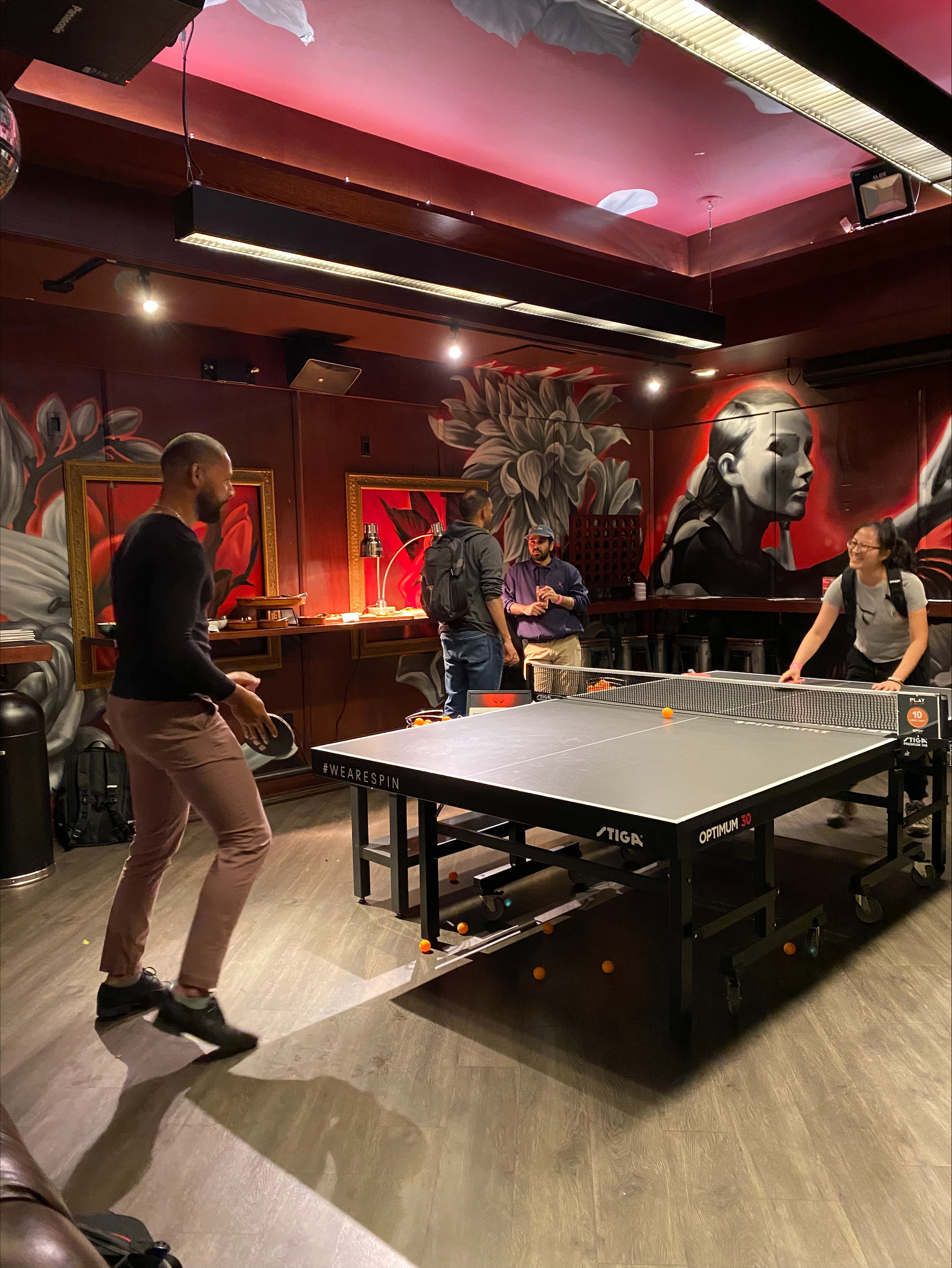 An image of people playing ping-pong at the Seattle developer meetup.